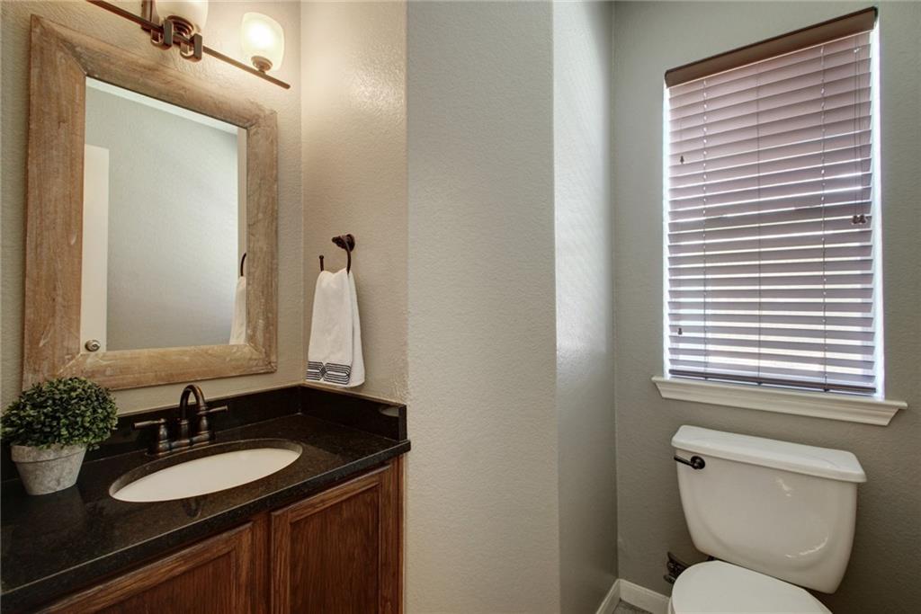 714 Adler Falls Lane Round Rock, TX 78665 - Photo 9 of 18 a bathroom with a granite countertop sink toilet and mirror