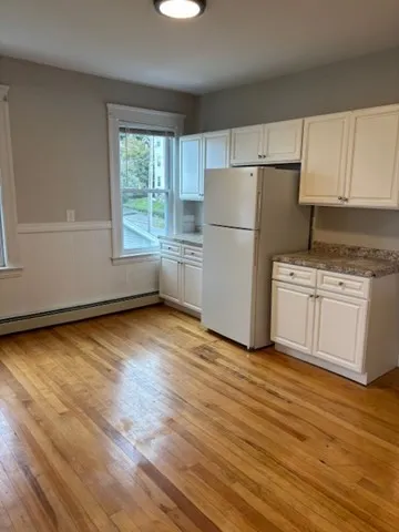 a kitchen with granite countertop a refrigerator stove top oven and sink