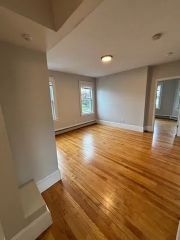 wooden floor in an empty room with a window