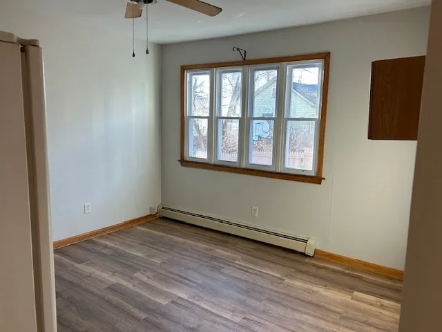 a kitchen with a stove cabinets and a wooden floor