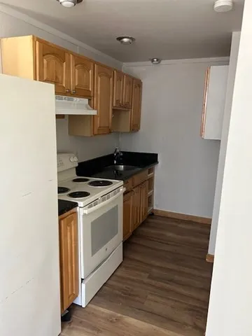 a kitchen with stainless steel appliances granite countertop a sink stove and cabinets