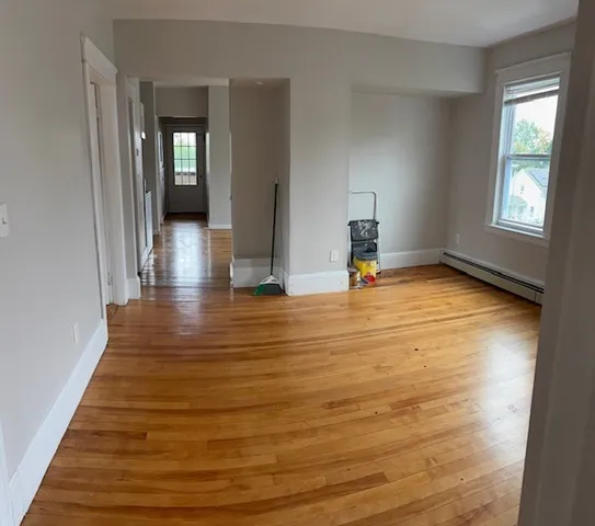 a view of a room with wooden floor and chair