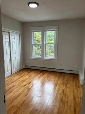 a view of a room with wooden floor and windows