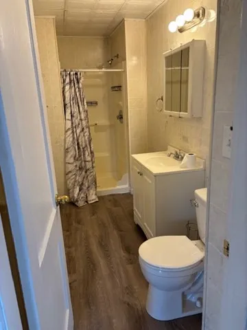 a bathroom with a toilet and a shower