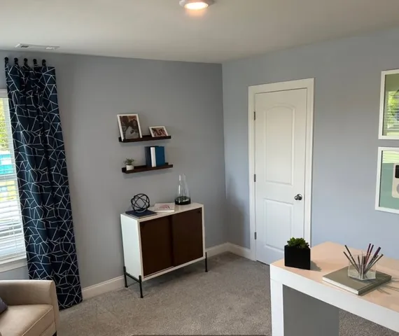 a room with a window and dresser