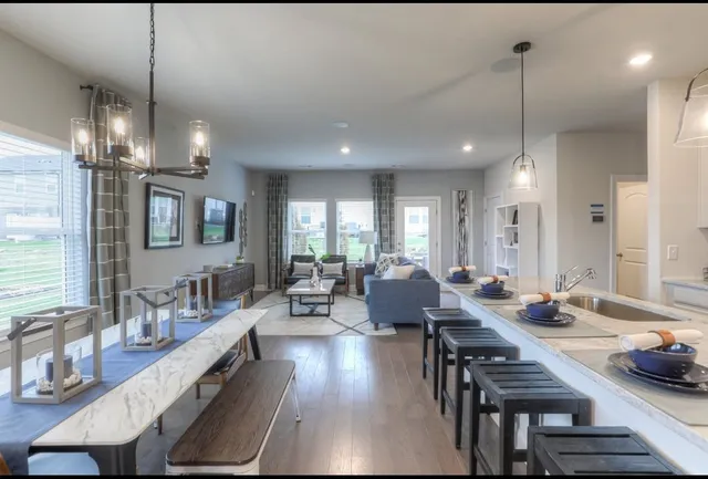 a large kitchen with a table and chairs
