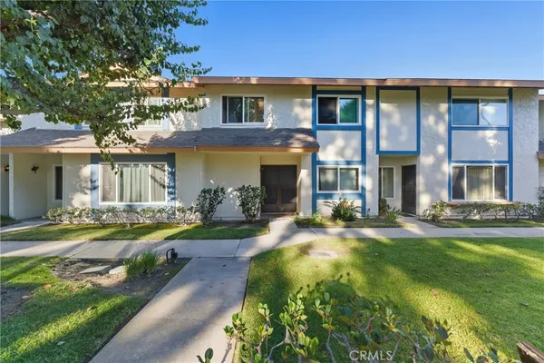 a front view of a house with swimming pool having outdoor seating