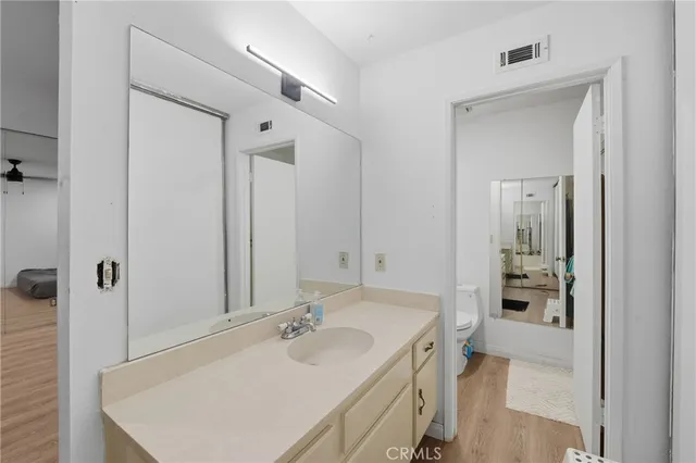 a bathroom with a sink a mirror and shower