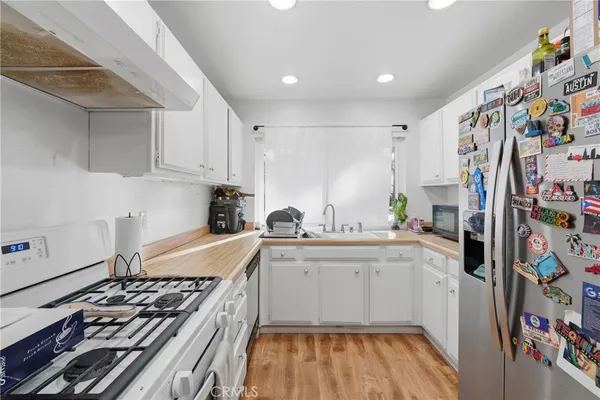 a kitchen with stainless steel appliances granite countertop a sink and cabinets
