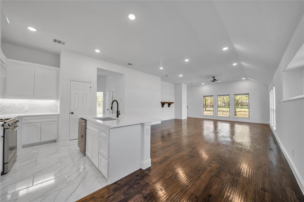 817 North Virginia Street Terrell, TX 75160 - Photo 6 of 20 a view of a kitchen with a sink and wooden floor