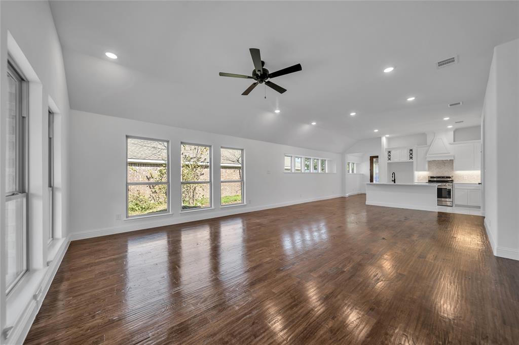 817 North Virginia Street Terrell, TX 75160 - Photo 7 of 20 a view of a kitchen and an empty room with wooden floor and a window
