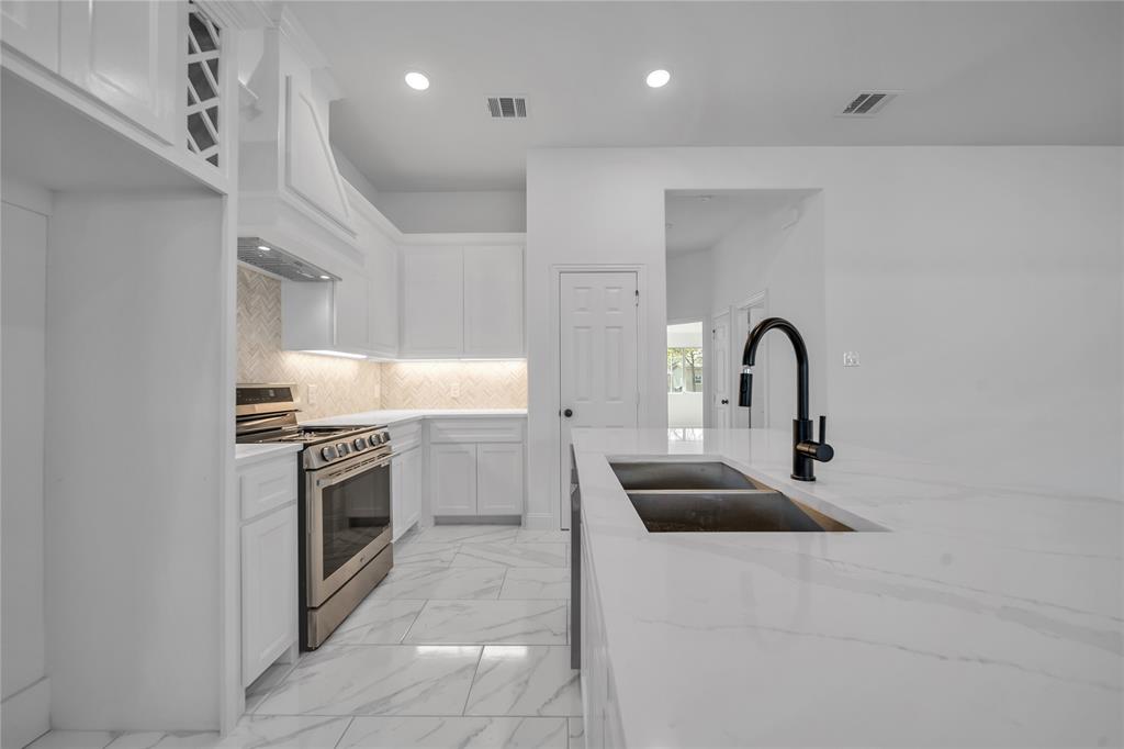 817 North Virginia Street Terrell, TX 75160 - Photo 9 of 20 a kitchen with stainless steel appliances granite countertop a sink a stove and a refrigerator