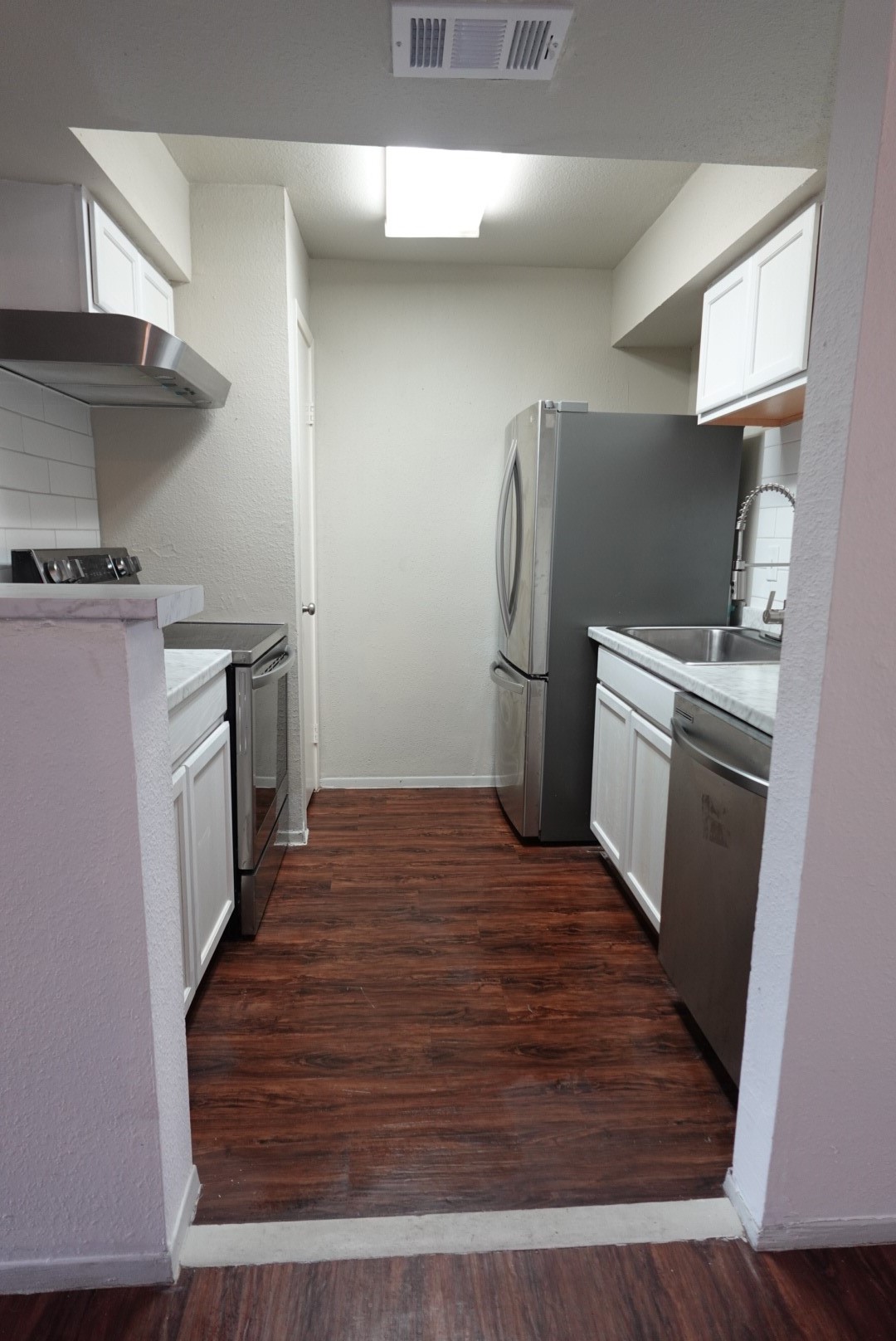 6001 Reims Road, Unit 1207 Houston, TX 77036 - Photo 11 of 36 a kitchen with a sink and a stove