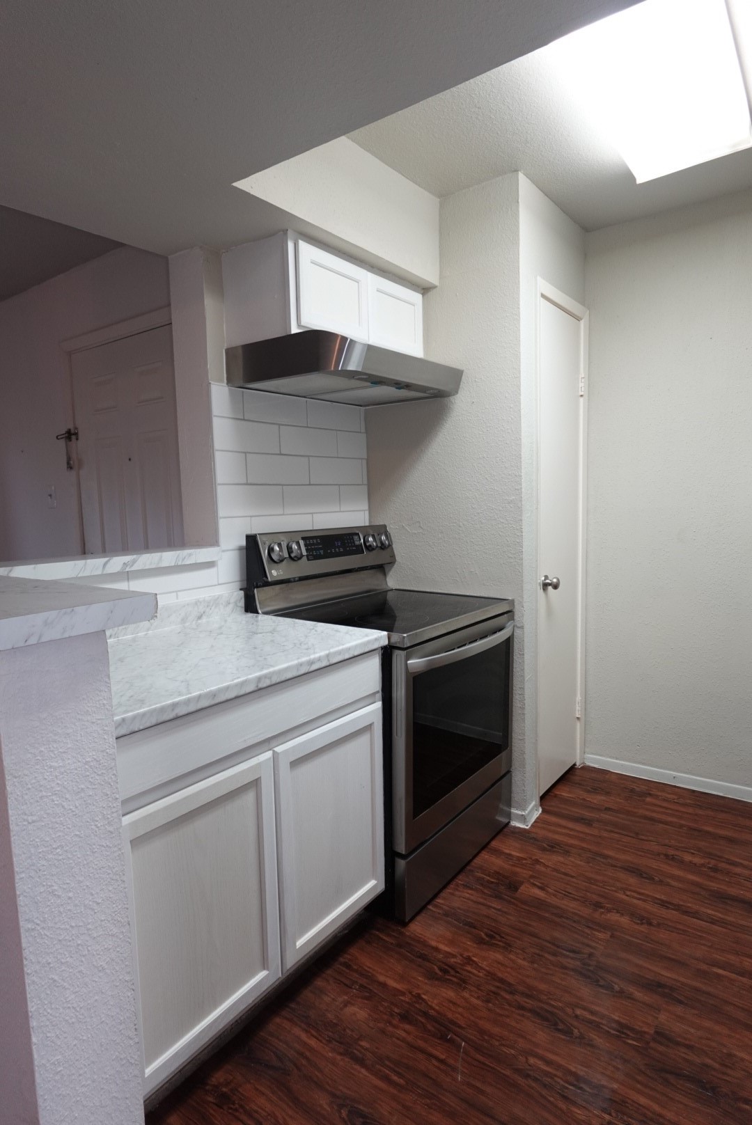 6001 Reims Road, Unit 1207 Houston, TX 77036 - Photo 12 of 36 a kitchen with a stove and a microwave