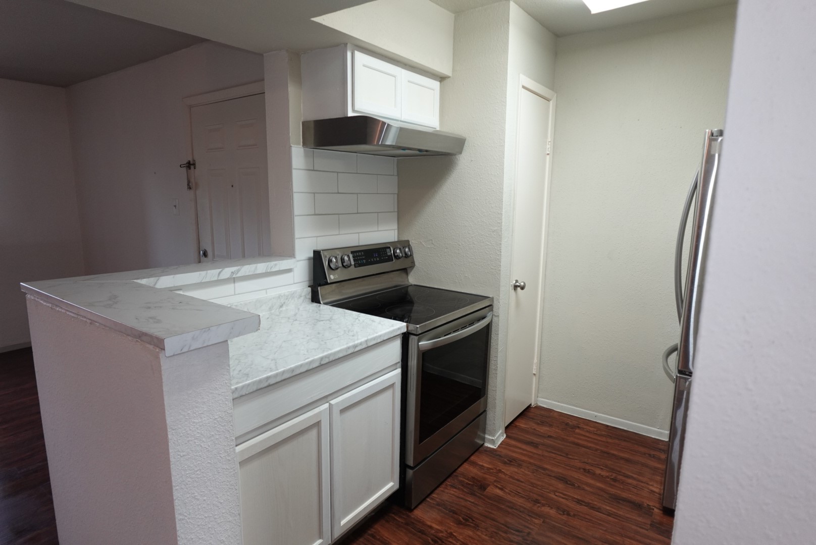 6001 Reims Road, Unit 1207 Houston, TX 77036 - Photo 13 of 36 a kitchen with a stove and a refrigerator