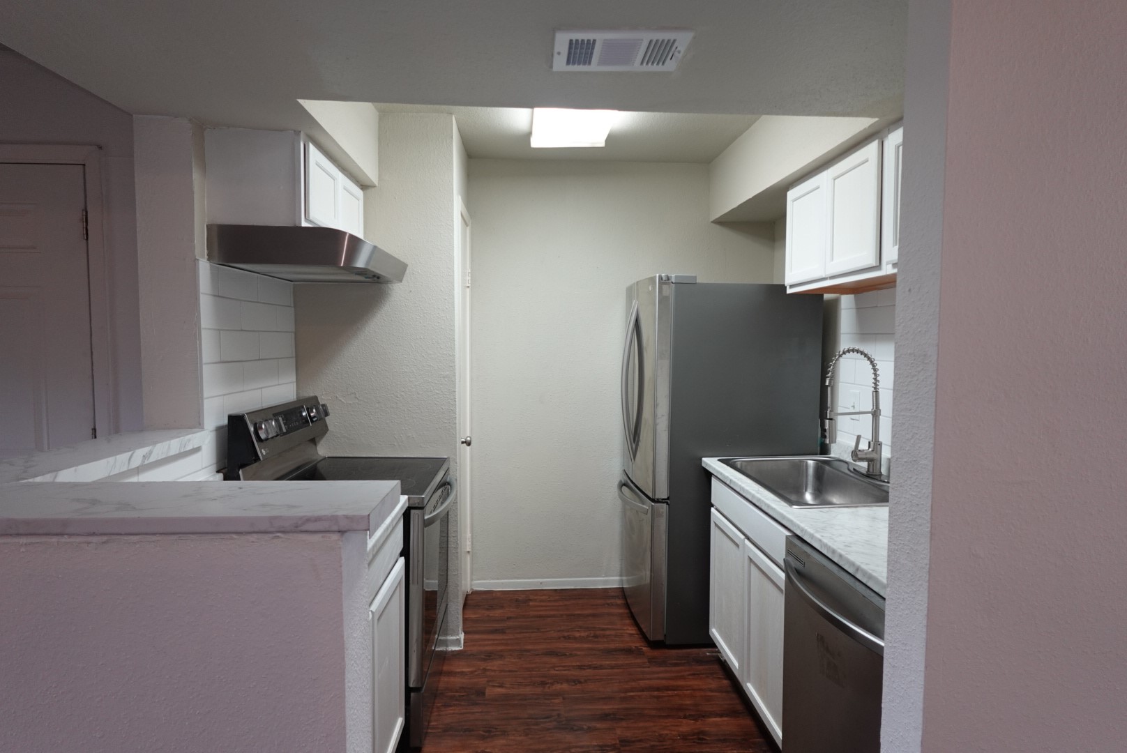 6001 Reims Road, Unit 1207 Houston, TX 77036 - Photo 14 of 36 a kitchen with a refrigerator sink and stove