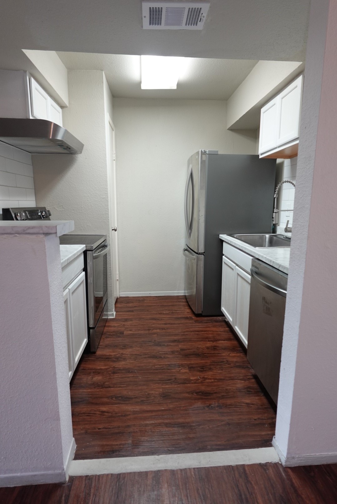 6001 Reims Road, Unit 1207 Houston, TX 77036 - Photo 16 of 36 a kitchen with a sink and a stove