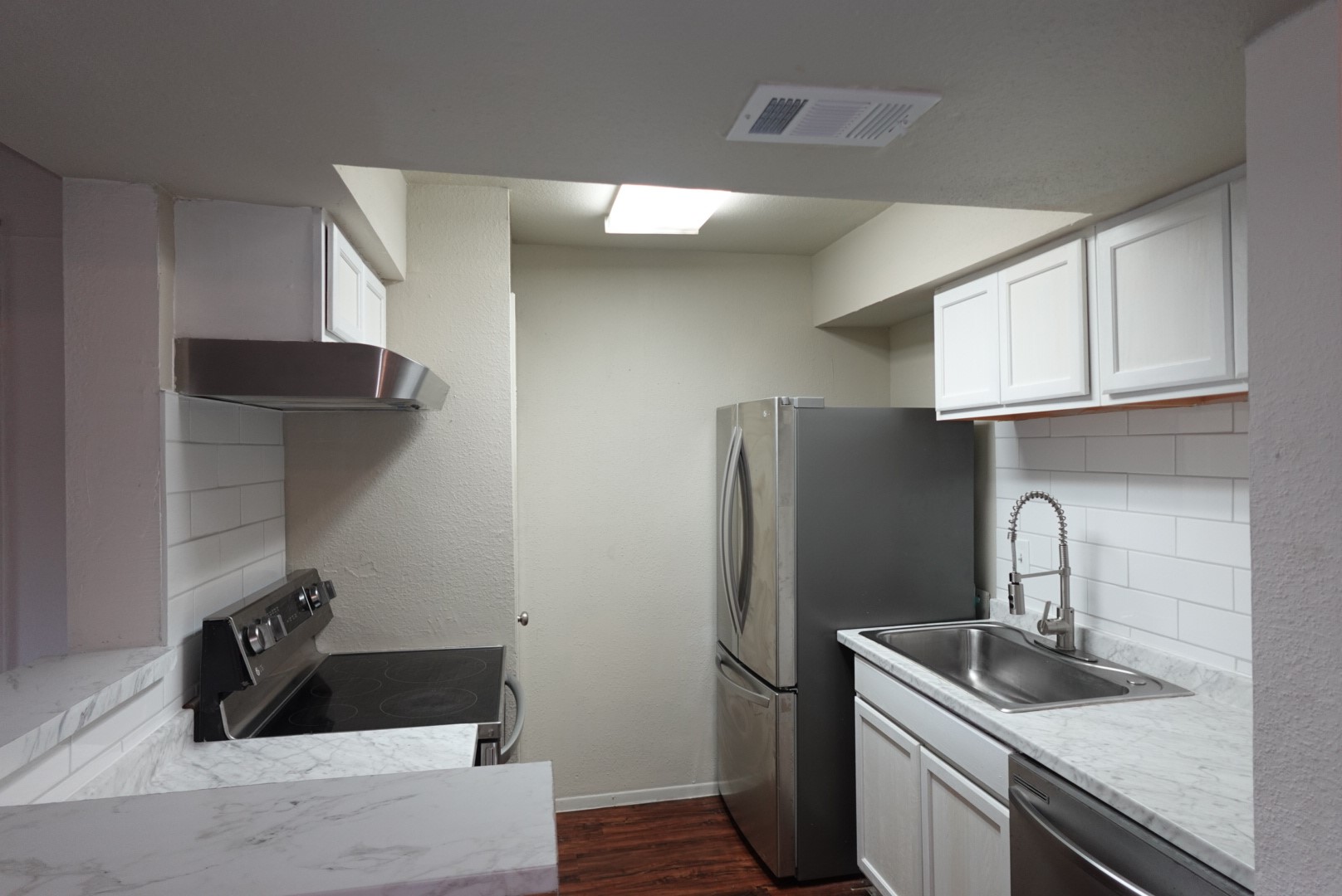 6001 Reims Road, Unit 1207 Houston, TX 77036 - Photo 18 of 36 a kitchen with stainless steel appliances granite countertop a sink stove and refrigerator