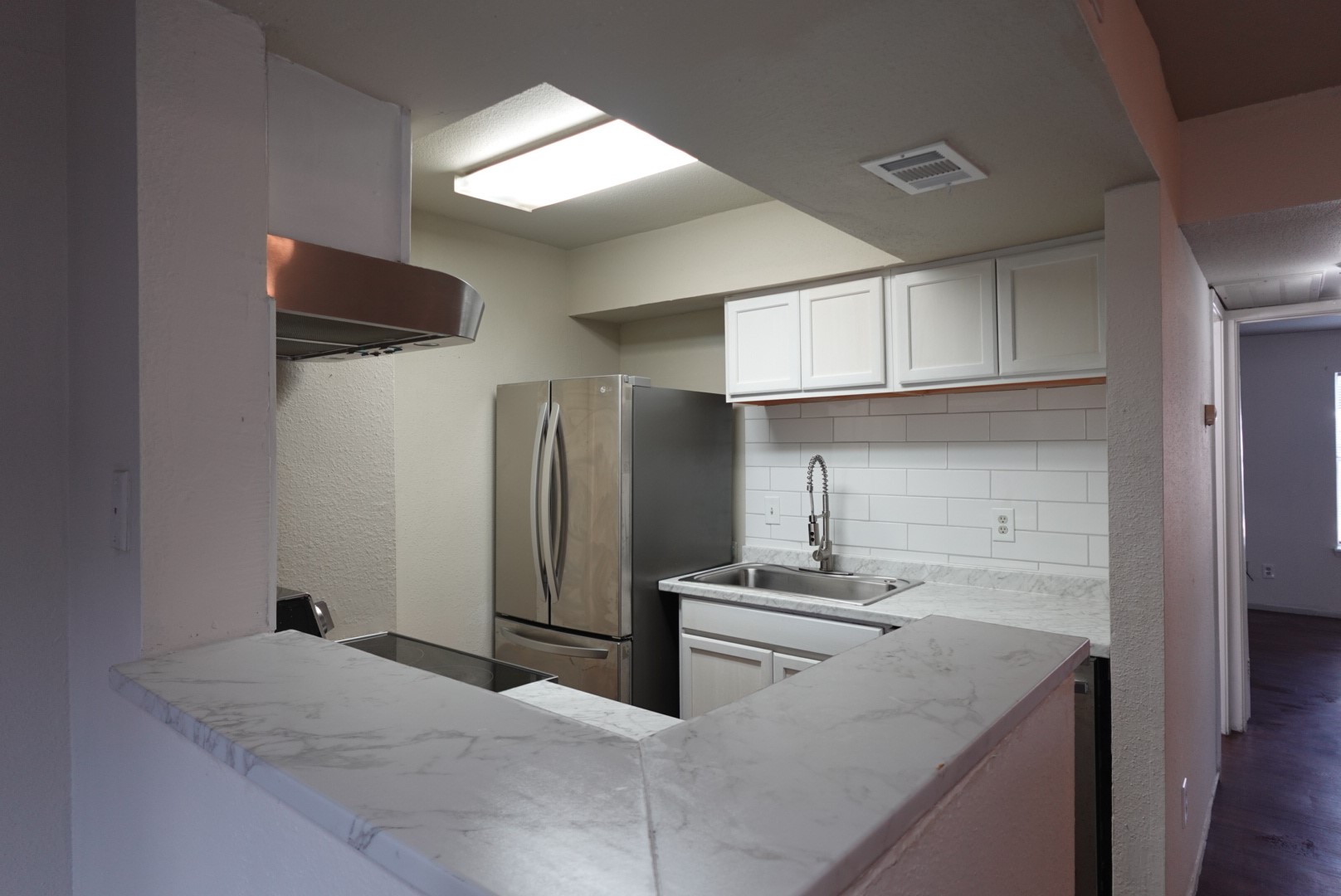 6001 Reims Road, Unit 1207 Houston, TX 77036 - Photo 20 of 36 a kitchen with stainless steel appliances kitchen island granite countertop a refrigerator and a sink