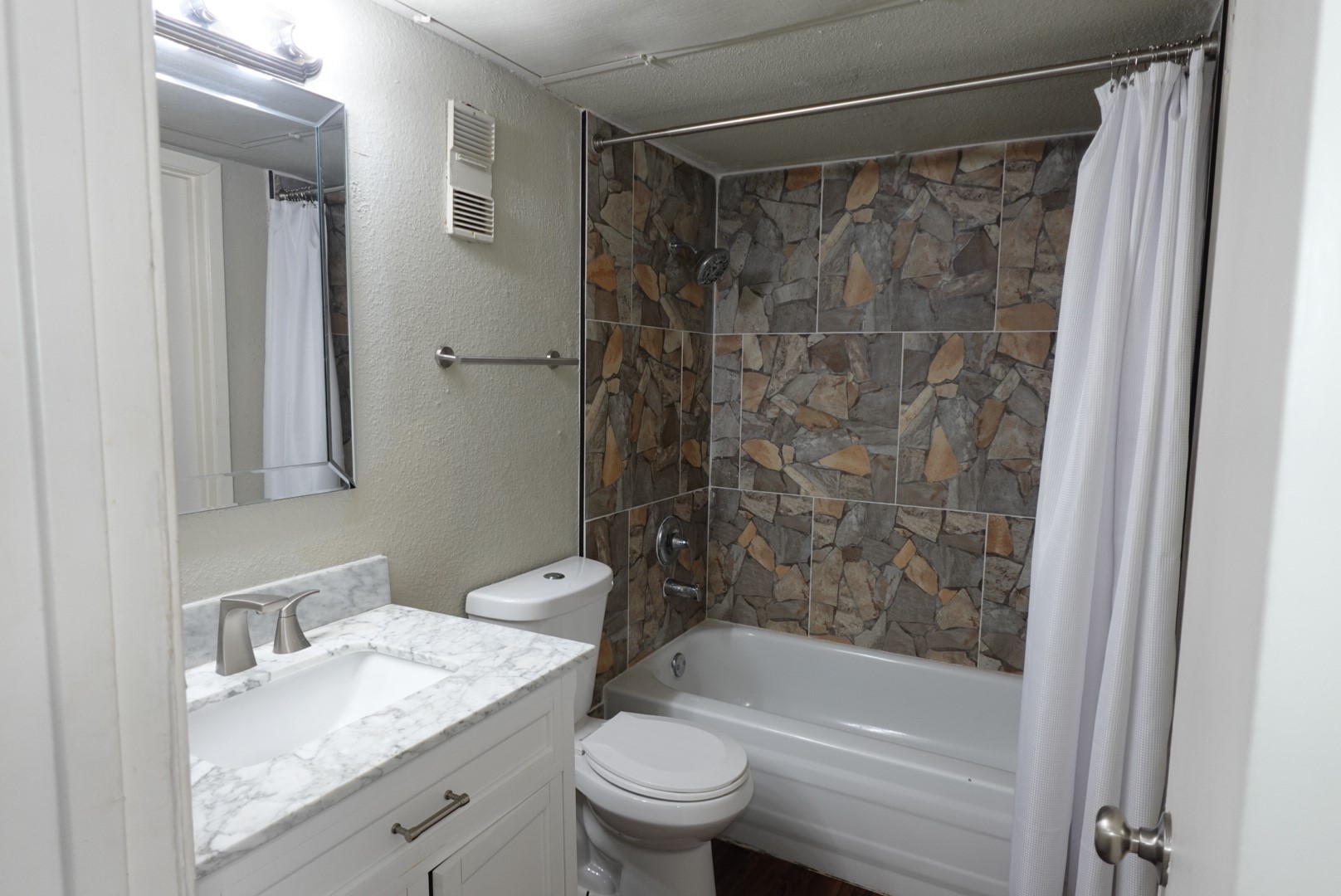 6001 Reims Road, Unit 1207 Houston, TX 77036 - Photo 22 of 36 a bathroom with a granite countertop sink toilet and shower