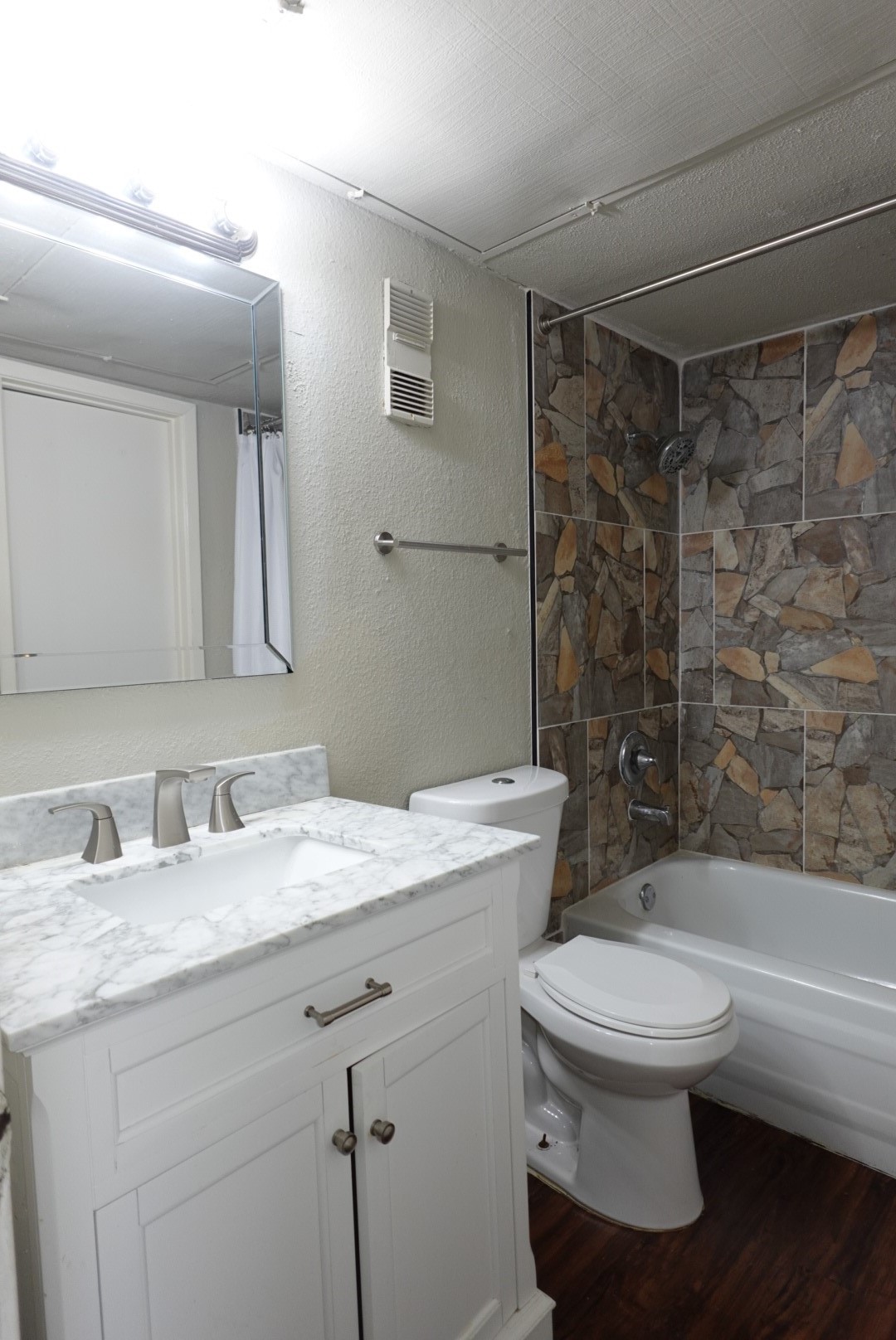 6001 Reims Road, Unit 1207 Houston, TX 77036 - Photo 23 of 36 a bathroom with a granite countertop sink toilet a mirror and shower