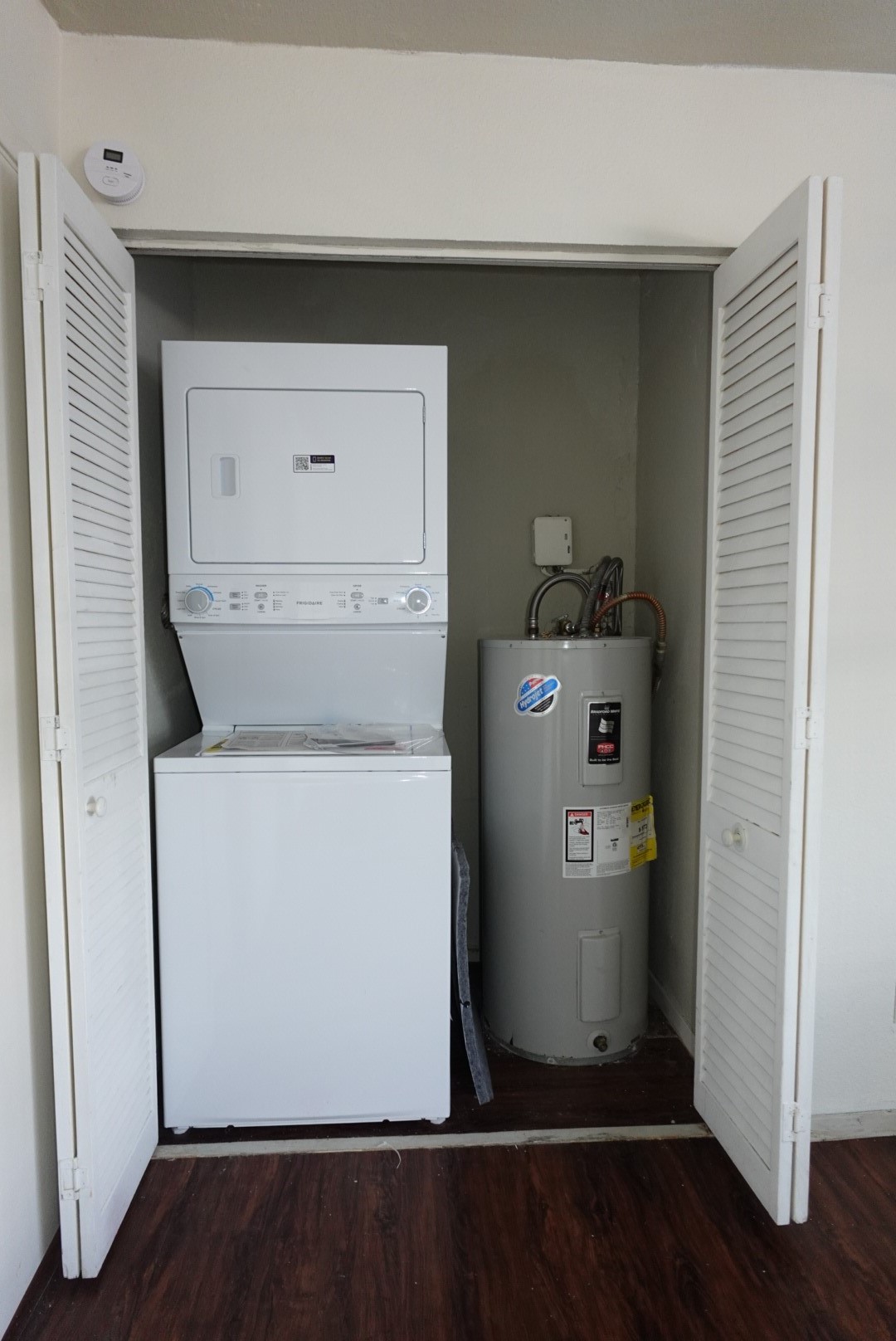 6001 Reims Road, Unit 1207 Houston, TX 77036 - Photo 25 of 36 a utility room with wooden floor washer and dryer