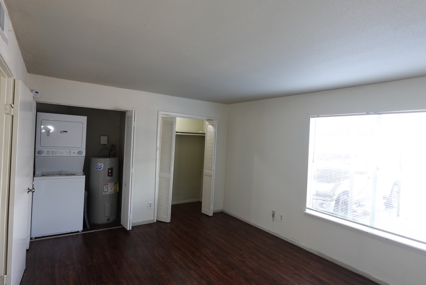 6001 Reims Road, Unit 1207 Houston, TX 77036 - Photo 26 of 36 wooden floor in an empty room with a window