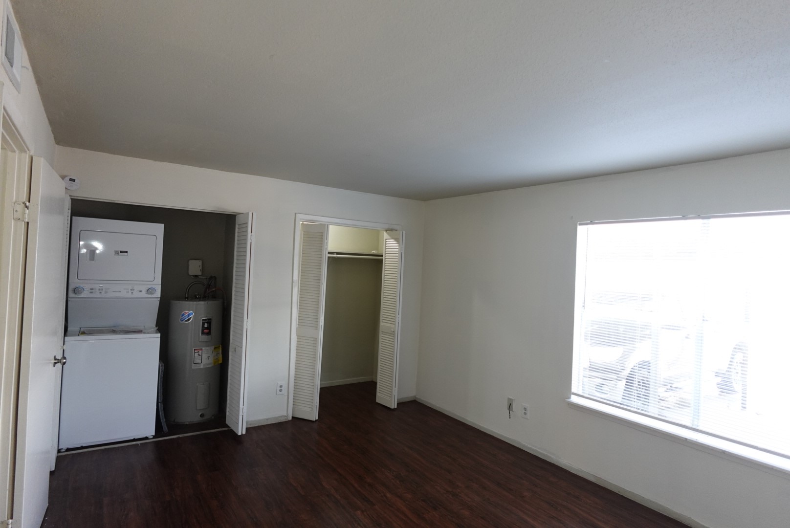 6001 Reims Road, Unit 1207 Houston, TX 77036 - Photo 27 of 36 an empty room with wooden floor and windows