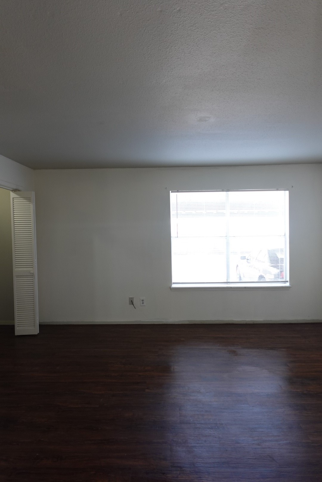 6001 Reims Road, Unit 1207 Houston, TX 77036 - Photo 30 of 36 a view of an empty room and wooden floor and a window