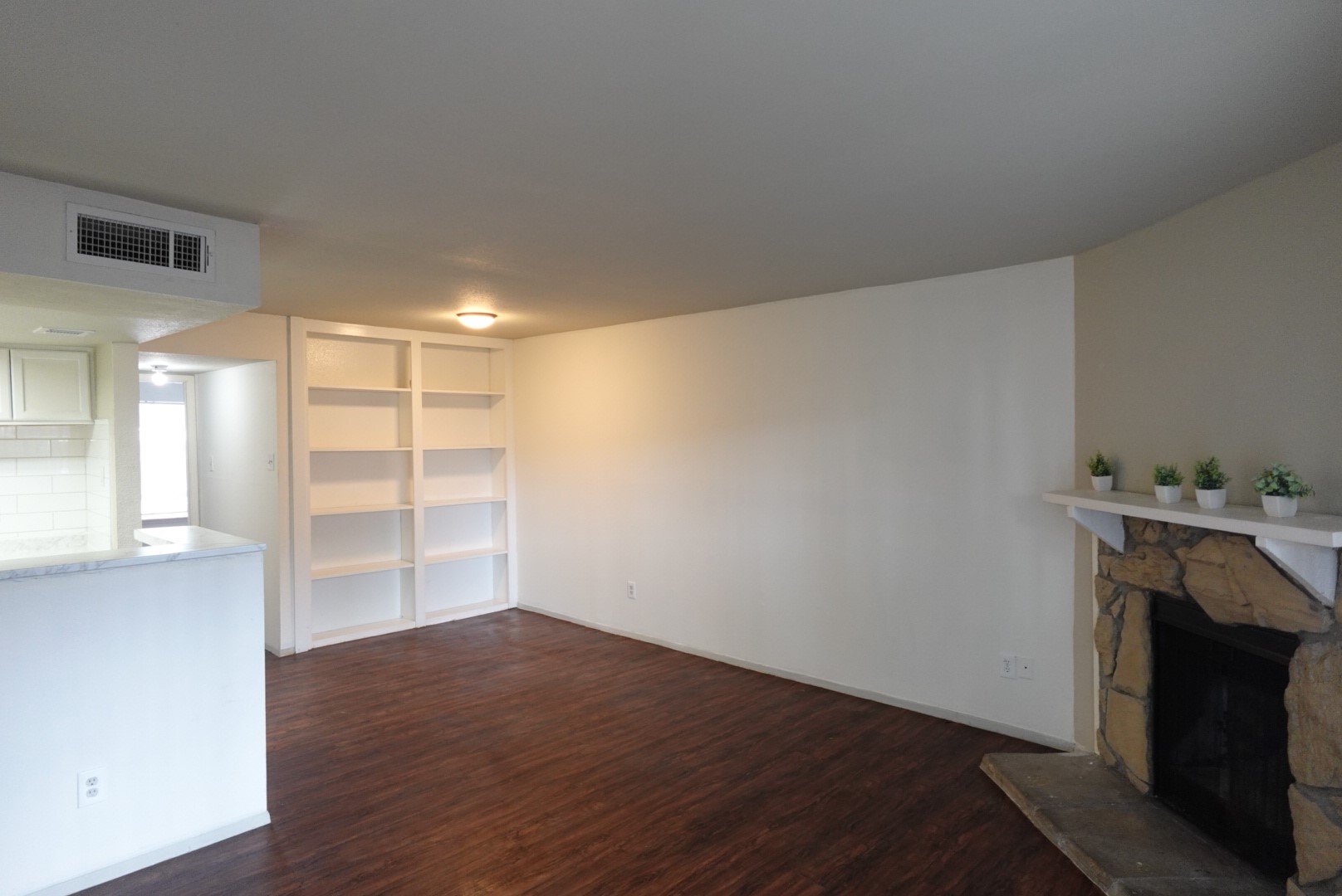 6001 Reims Road, Unit 1207 Houston, TX 77036 - Photo 3 of 36 a view of empty room with wooden floor and fireplace