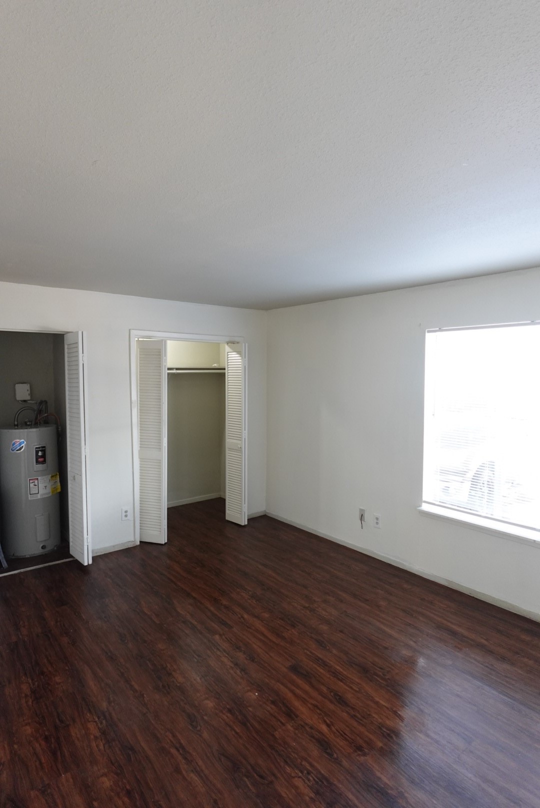 6001 Reims Road, Unit 1207 Houston, TX 77036 - Photo 31 of 36 an empty room with wooden floor and windows