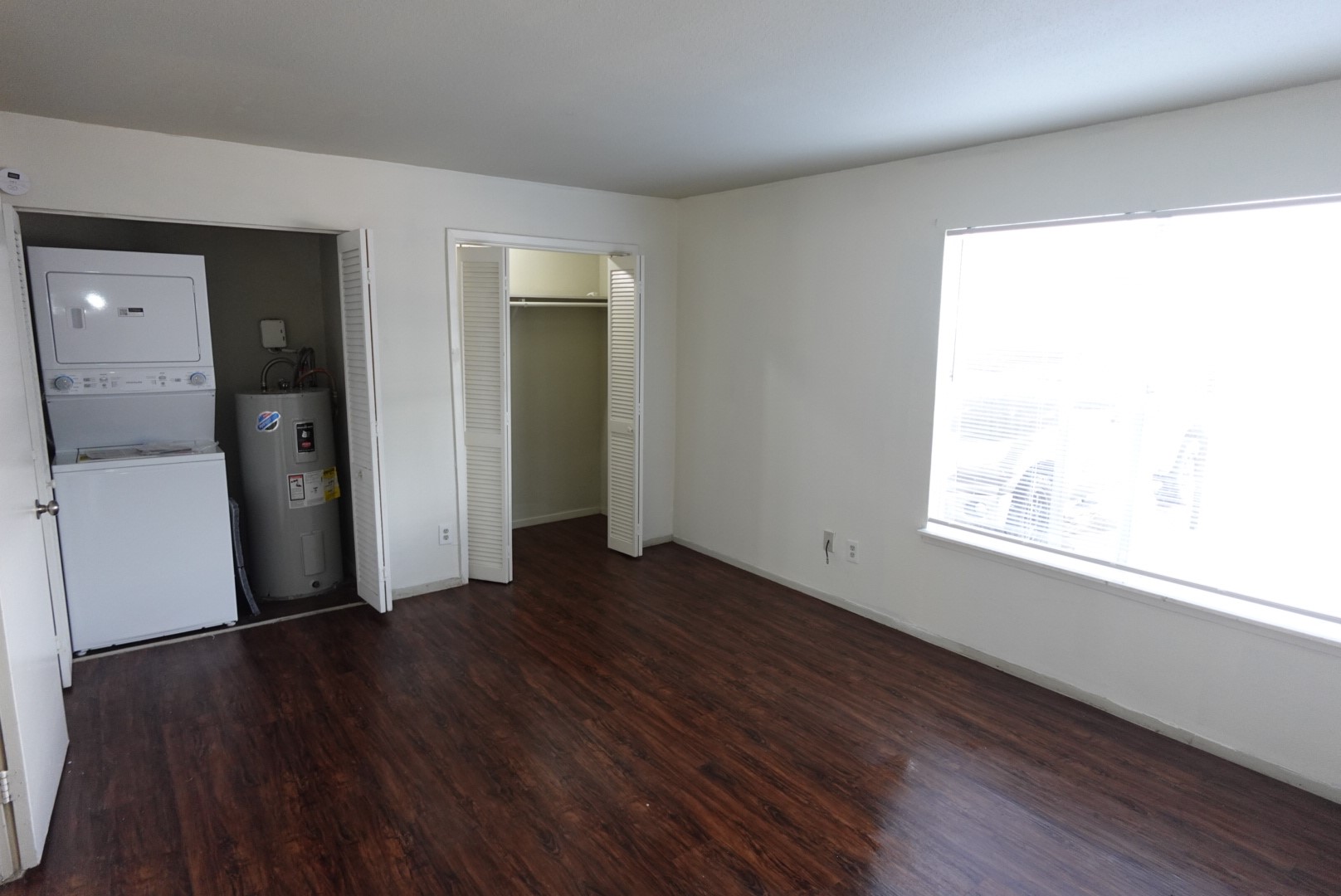 6001 Reims Road, Unit 1207 Houston, TX 77036 - Photo 32 of 36 an empty room with wooden floor and windows
