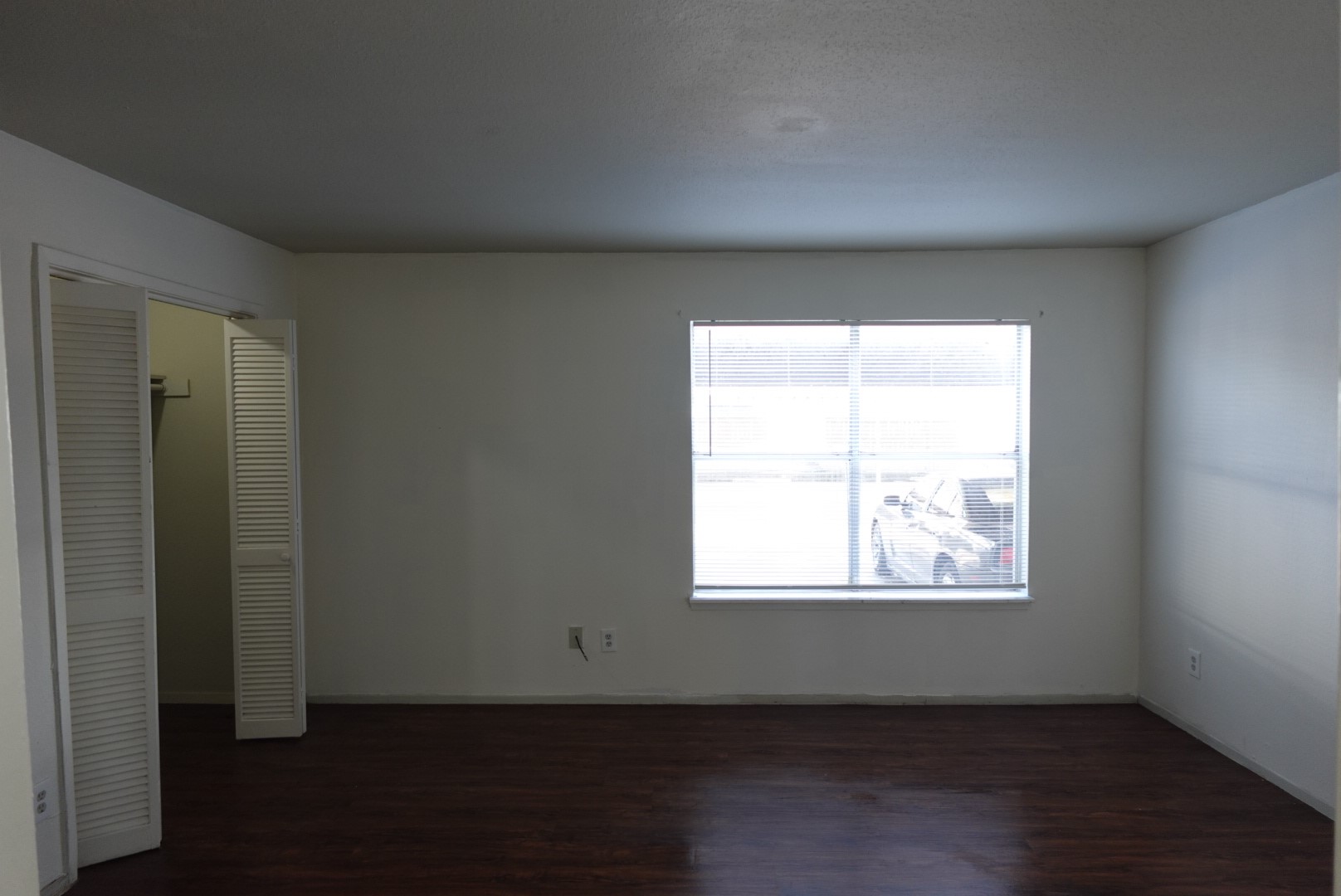 6001 Reims Road, Unit 1207 Houston, TX 77036 - Photo 33 of 36 an empty room with wooden floor and windows