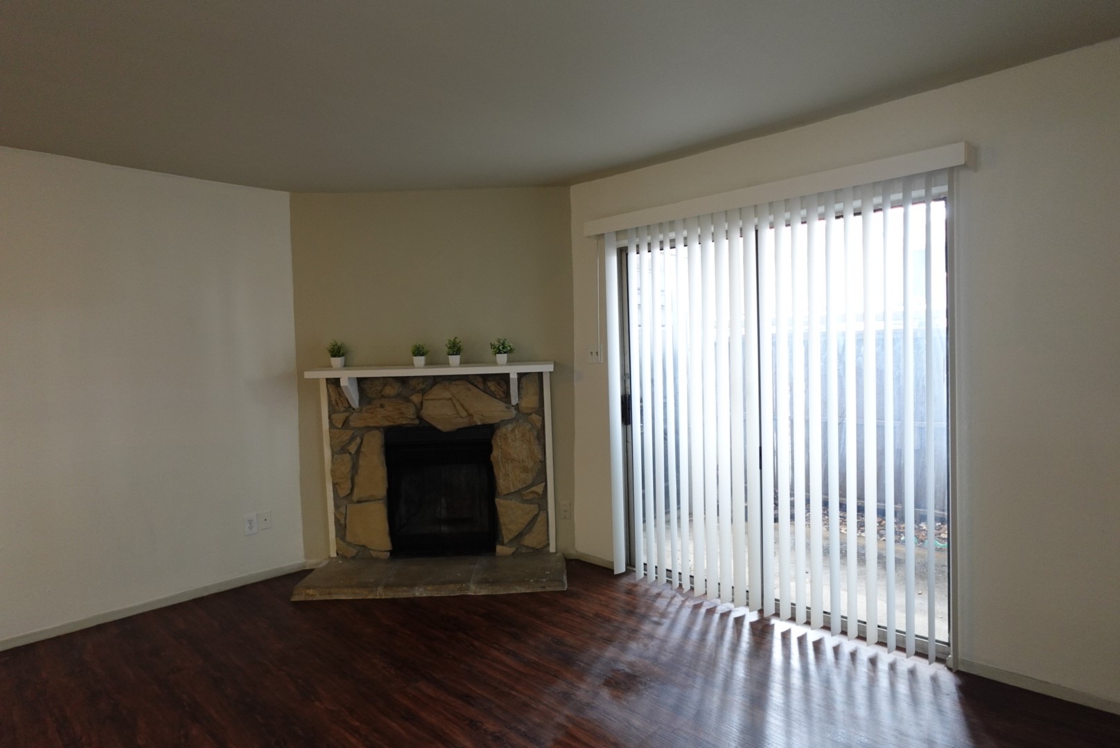 6001 Reims Road, Unit 1207 Houston, TX 77036 - Photo 6 of 36 a view of an empty room with wooden floor and a window