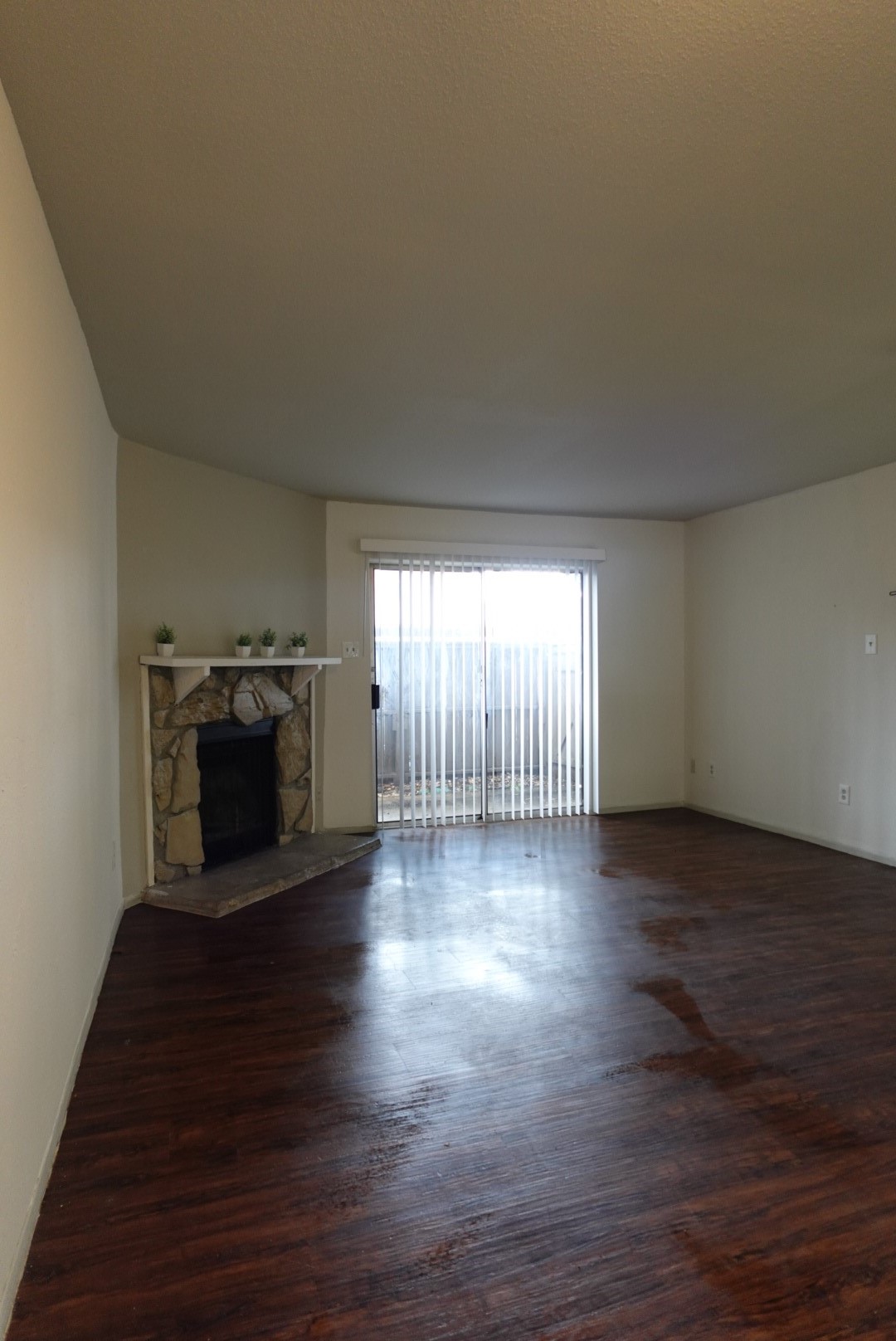 6001 Reims Road, Unit 1207 Houston, TX 77036 - Photo 10 of 36 an empty room with wooden floor fireplace and windows