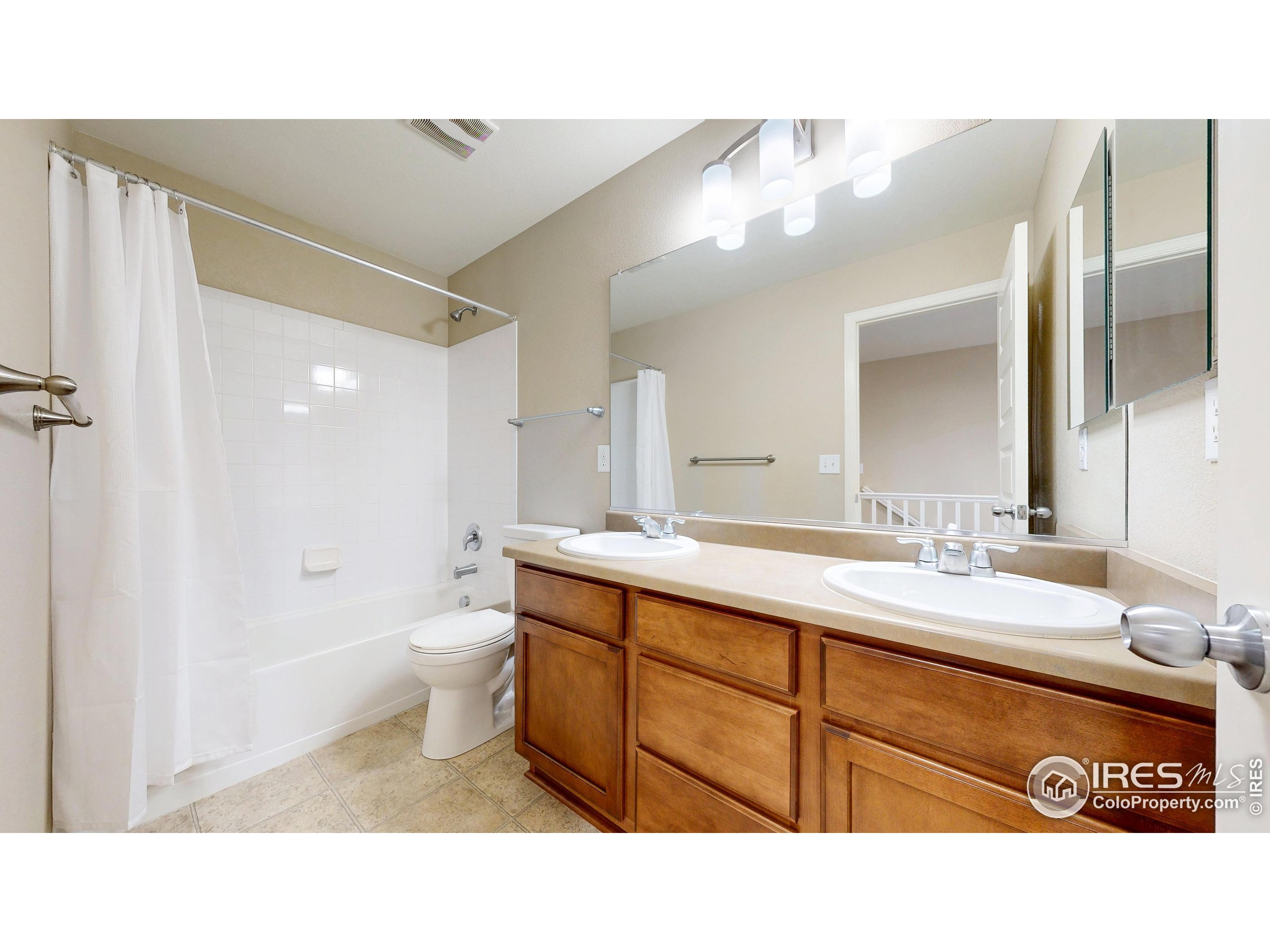 5543 Calgary Street Timnath, CO 80547 - Photo 26 of 38 a bathroom with a sink a toilet and a mirror
