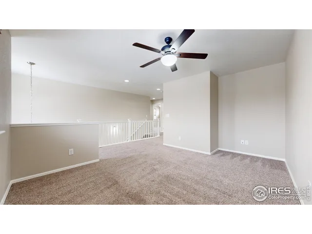 a kitchen with white cabinets and window