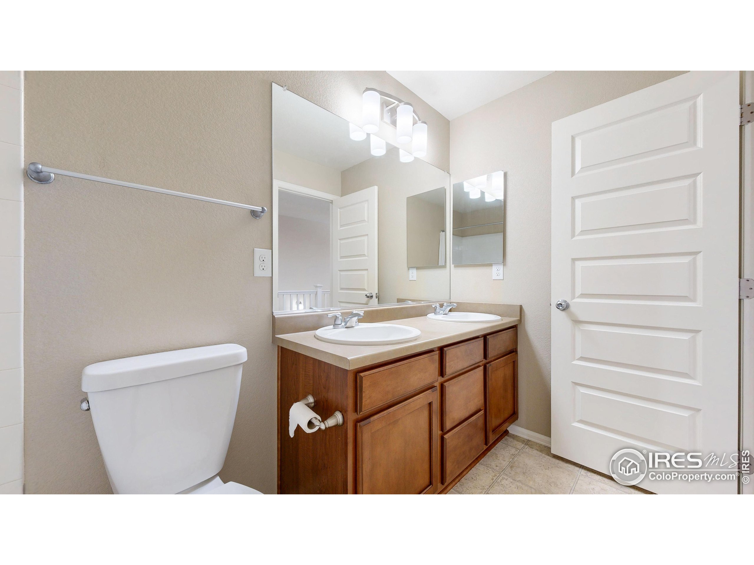 5543 Calgary Street Timnath, CO 80547 - Photo 32 of 38 a bathroom with a sink a toilet and a mirror