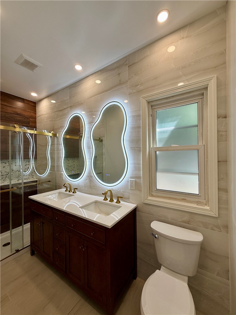 171 Cedarwood Terrace Rochester, NY 14609 - Photo 11 of 29 A full bath on the first floor with dual sinks and dual smart mirrors.