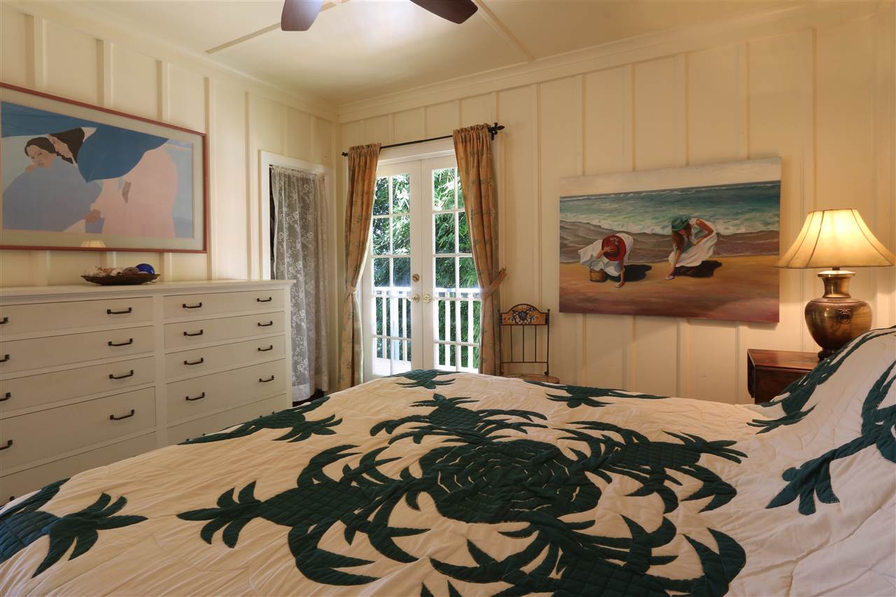 5231 Lower Kula Road Kula, HI 96790 - Photo 14 of 29 a bedroom with a bed and a flat tv screen on dresser