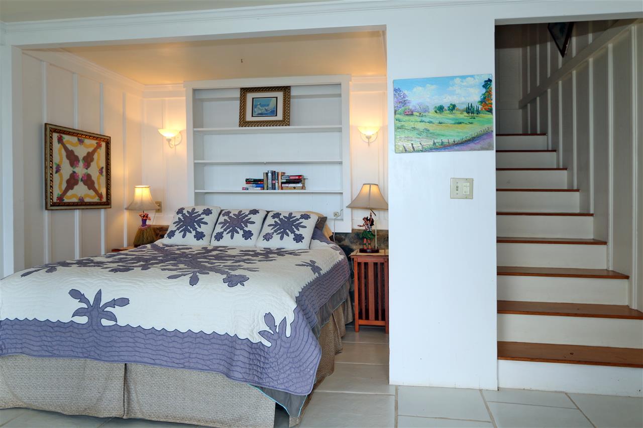 5231 Lower Kula Road Kula, HI 96790 - Photo 16 of 29 a view of a bedroom with furniture and staircase