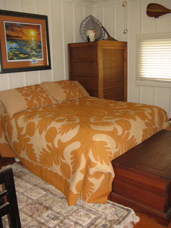 5231 Lower Kula Road Kula, HI 96790 - Photo 23 of 29 a bedroom with a bed and wooden floor