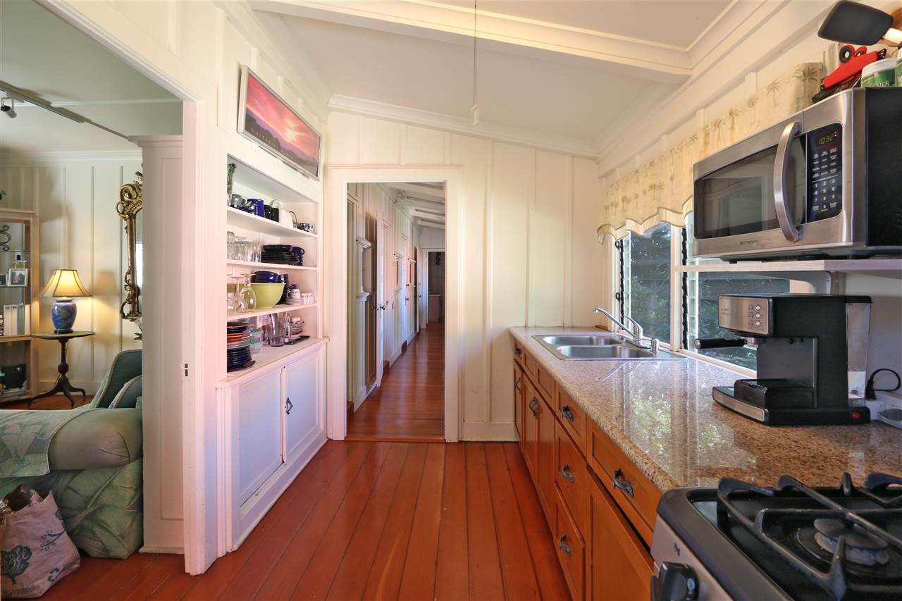 5231 Lower Kula Road Kula, HI 96790 - Photo 26 of 29 a kitchen with stainless steel appliances a stove and a wooden floor