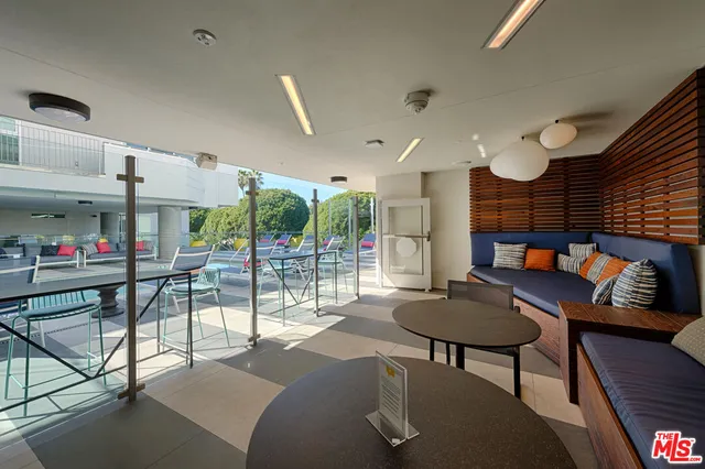 a living room with furniture and a floor to ceiling window
