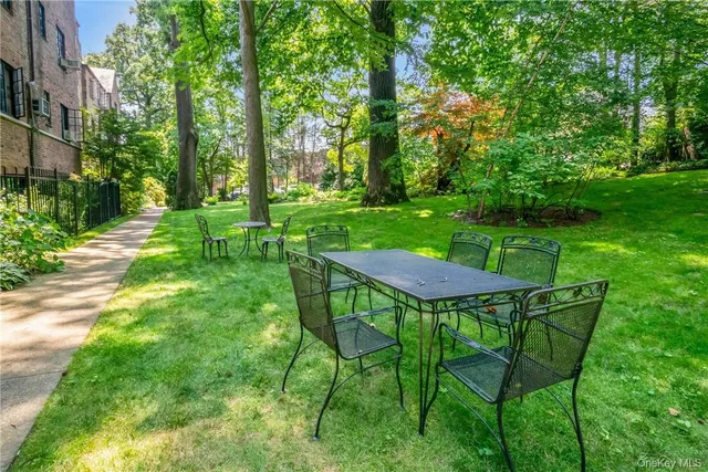 a view of a table and chairs in backyard