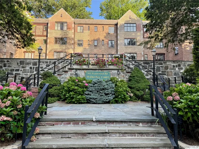 a view of a house with a garden and pathway
