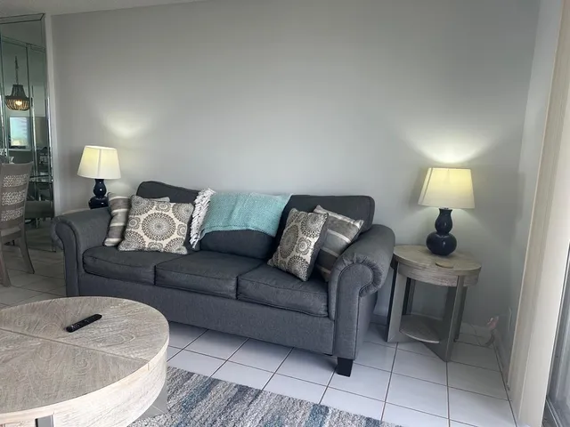 a living room with furniture and a lamp