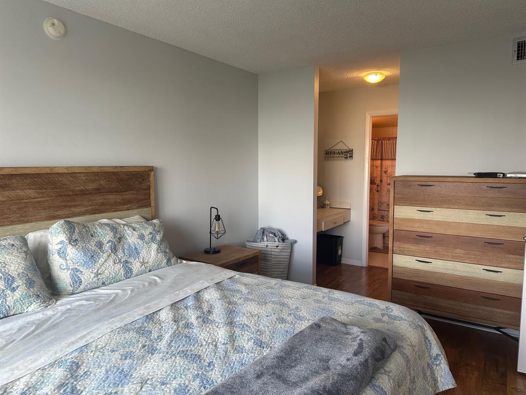 1009 North Ocean Boulevard, Unit 407 Pompano Beach, FL 33062 - Photo 17 of 35 a bedroom with a bed and wooden floor