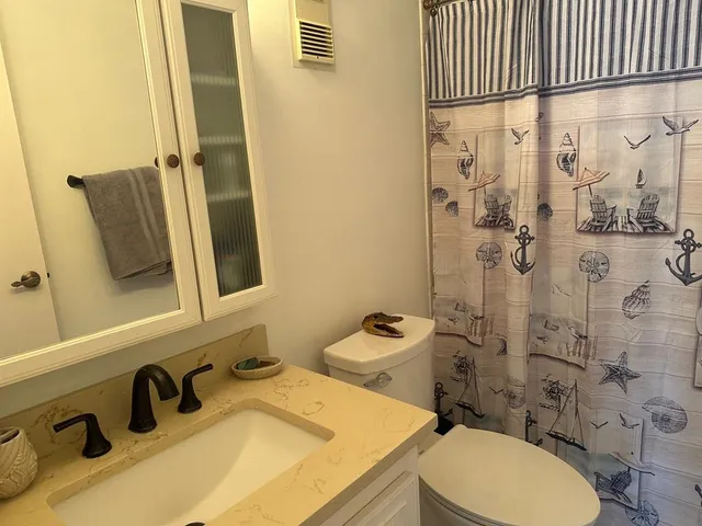 a bedroom with a bed and flat screen tv