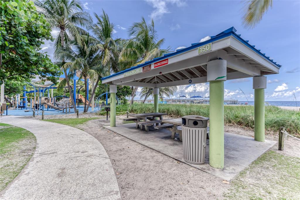 1009 North Ocean Boulevard, Unit 407 Pompano Beach, FL 33062 - Photo 34 of 35 a view of a porch with furniture and floor to ceiling window